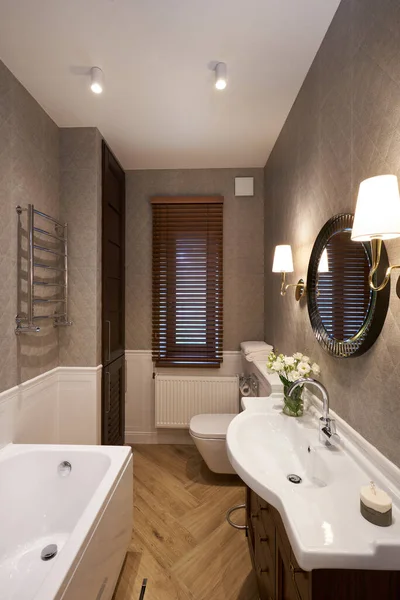 Modern Bathroom interior with stone wall, mirror and shower. Real photo.