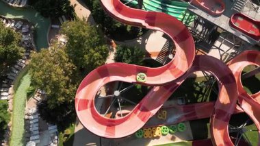 Su parkında şişme borulara binen insanların renkli su kaydıraklarının havadan görünüşü. Parlak yaz günü heyecan, eğlence ve heyecanla dolu..