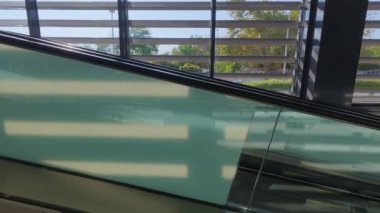 Empty moving walkway in modern airport or shopping mall, travelator perspective view, transport conveyor for passengers.