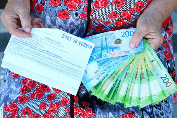 Invoice for payment and new Russian money in the hands of a woma