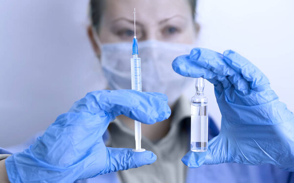 Concept doctor with a vaccine syringe. Protection against bacter