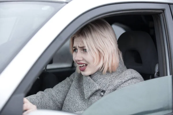 Young woman driving in an emergency stress situation — Stock Photo, Image