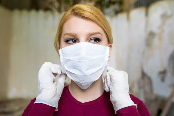 Young woman wearing the protection mask on her face.