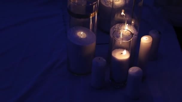 Candele in bottiglie e scatole di vetro sulla cerimonia di nozze all'aperto a tarda sera. Luci romantiche . — Video Stock