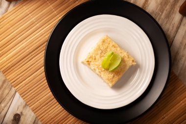 Carlota de Limon, a cold, no-bake dessert made with layers of Maria cookies and a creamy mixture of lemon and condensed milk, an easy homemade recipe very popular in Mexico.