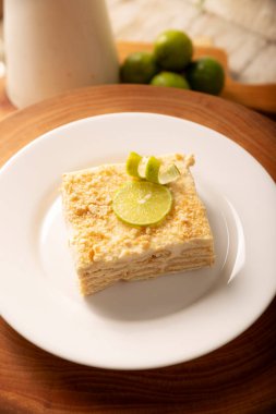 Carlota de Limon, a cold, no-bake dessert made with layers of Maria cookies and a creamy mixture of lemon and condensed milk, an easy homemade recipe very popular in Mexico.
