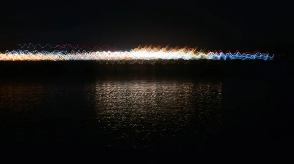 Light abstractions obtained at night on the water.