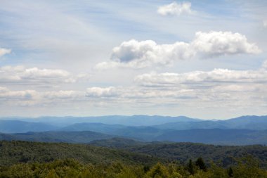 Panoramic Aerial View of Green Meadow with Sky and Mountain Horizon