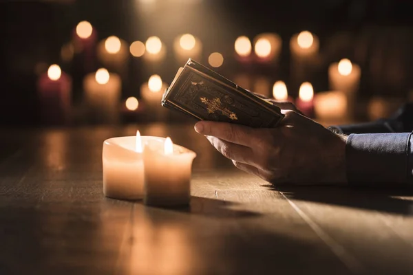 Religieuze Man Heilige Bijbel Lezen Bidden Kerk Met Verlichte Kaarsen — Stockfoto