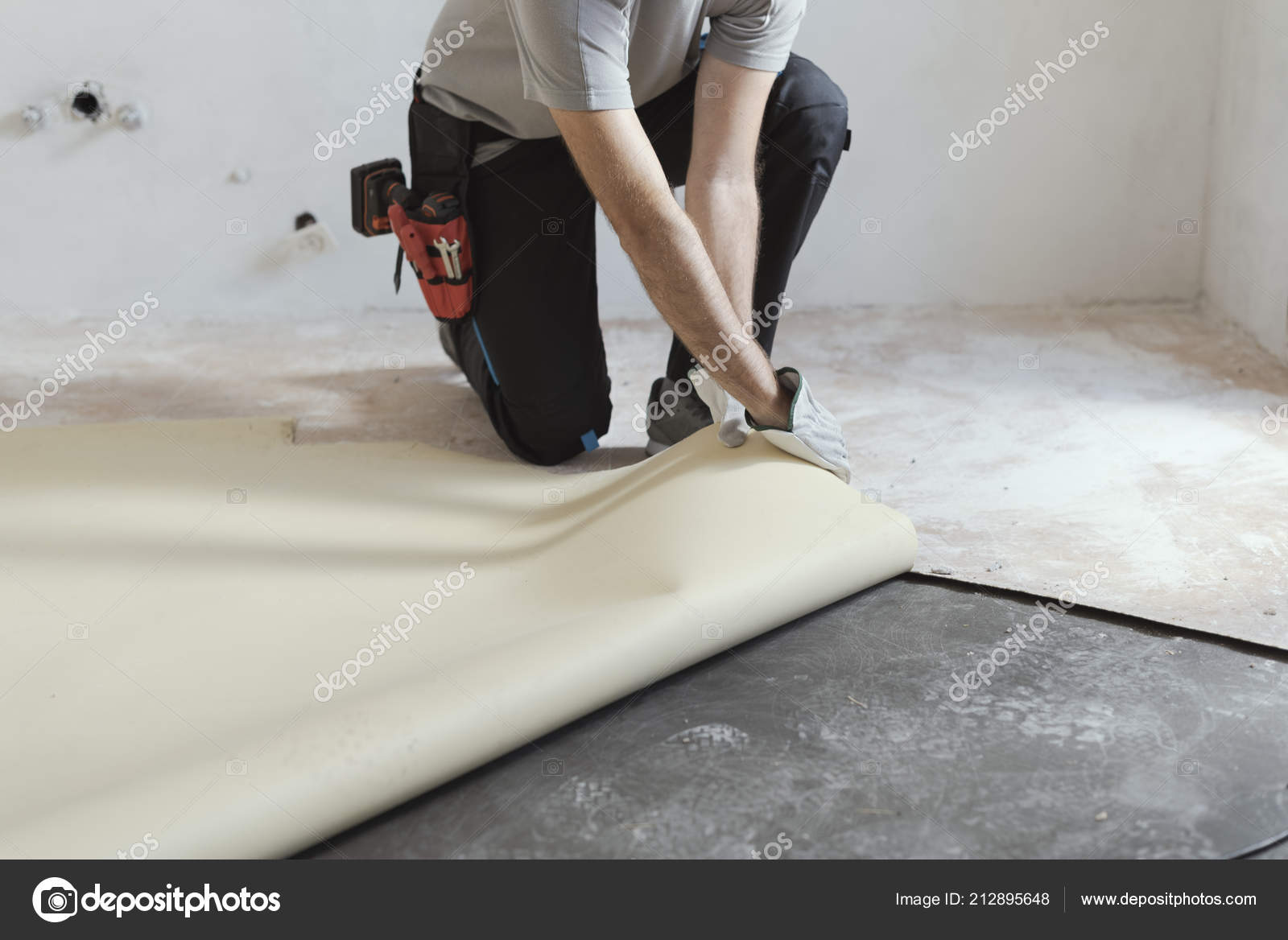 Professional Contractor Removing Old Linoleum Flooring Home