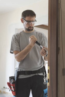 Profesyonel marangoz evde eski bir kapı kaldırma: makyaj ve yenileme ev concept