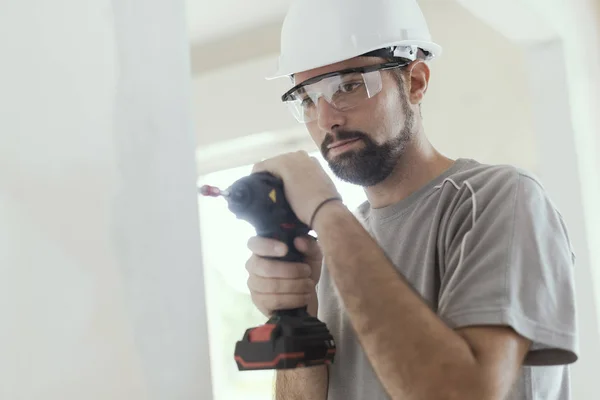 Professional Repairman Protective Goggles Using Drill Doing Home Renovation — Stock Photo, Image