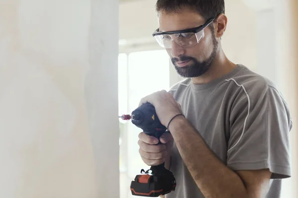 Professzionális Műszerész Védőszemüvegek Használ Egy Fúróval Csinál Egy Otthon Felújítása — Stock Fotó