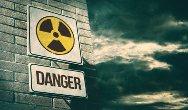 Radioactivity and chemical hazard street sign with toxic clouds on the background: pollution and danger concept clipart