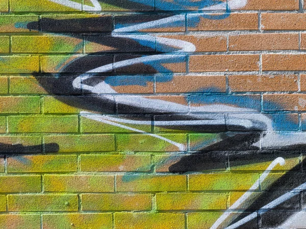 Creative street art graffiti on a brick wall: colorful abstract design close up
