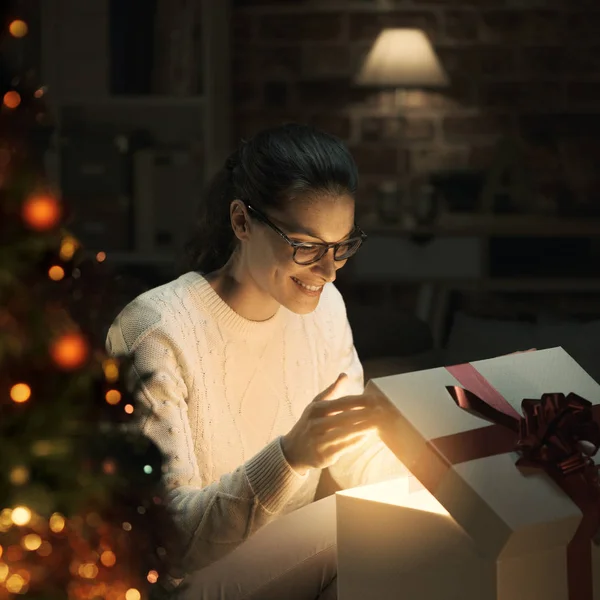 Glückliche Frau Öffnet Ein Zauberhaft Glänzendes Weihnachtsgeschenk Hause Weihnachtsbaum Vordergrund — Stockfoto