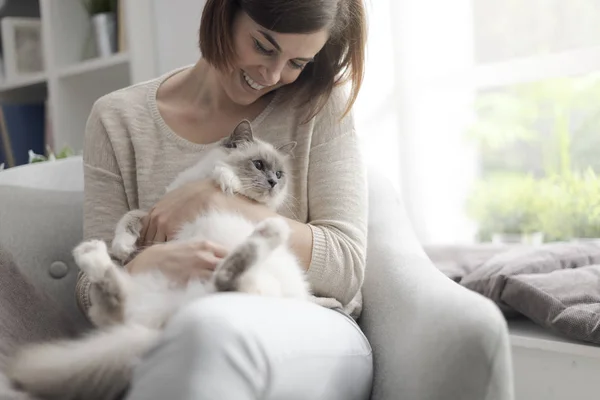 Joven Mujer Feliz Sentada Sillón Sala Estar Acariciando Hermoso Gato —  Fotos de Stock