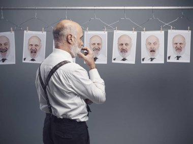 Olgun işadamı onun kişilik bölünmesi ve portreler asılı bir toplama ifadelerini bakıp: zihin kendini analiz ve duygular kavramı