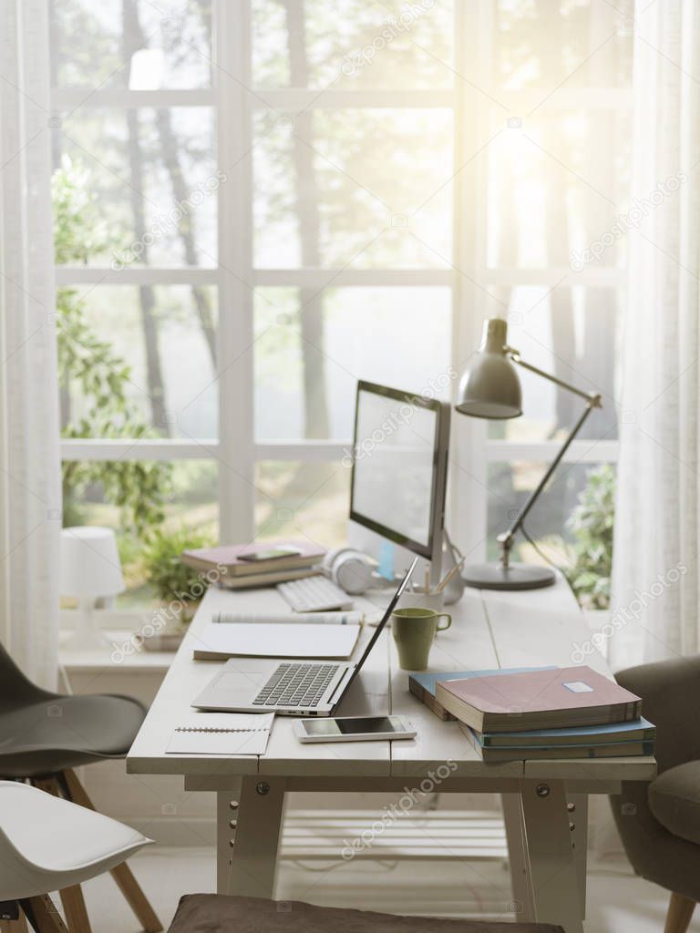 Modern student room with desk and computer, window in the background