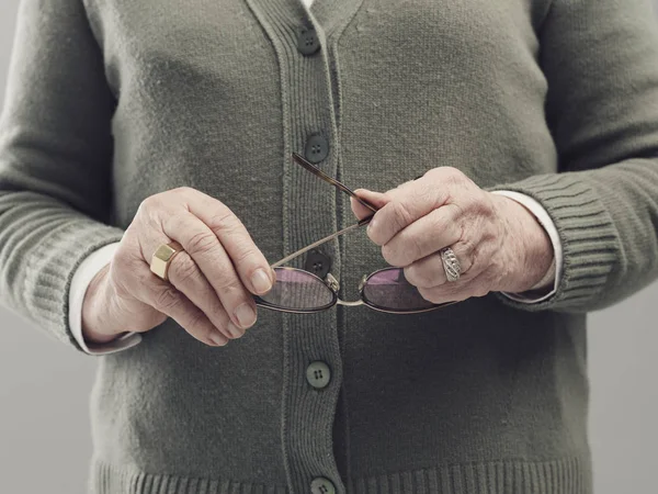 Senior lady hands holding glasses — Stock Photo, Image