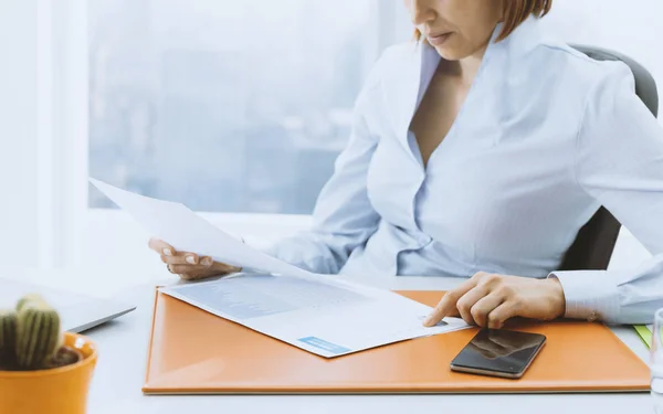 Business executive checking financial reports in the office — Stock Photo, Image