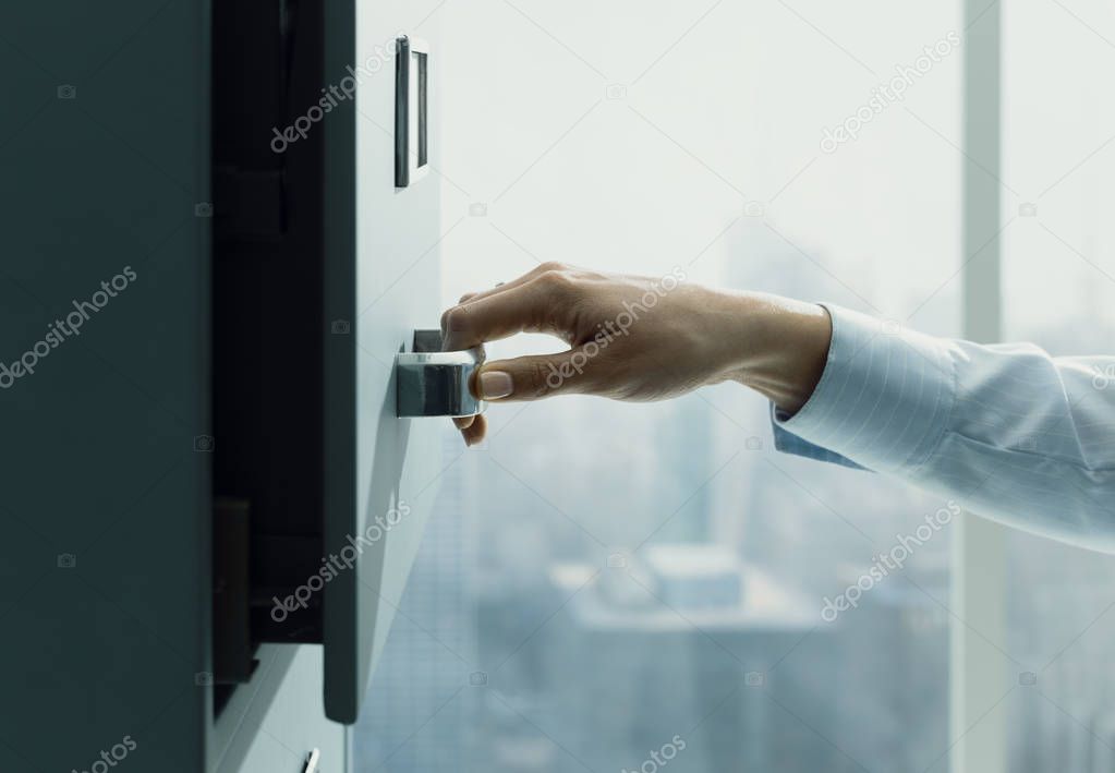 Secretary searching files in the filing cabinet