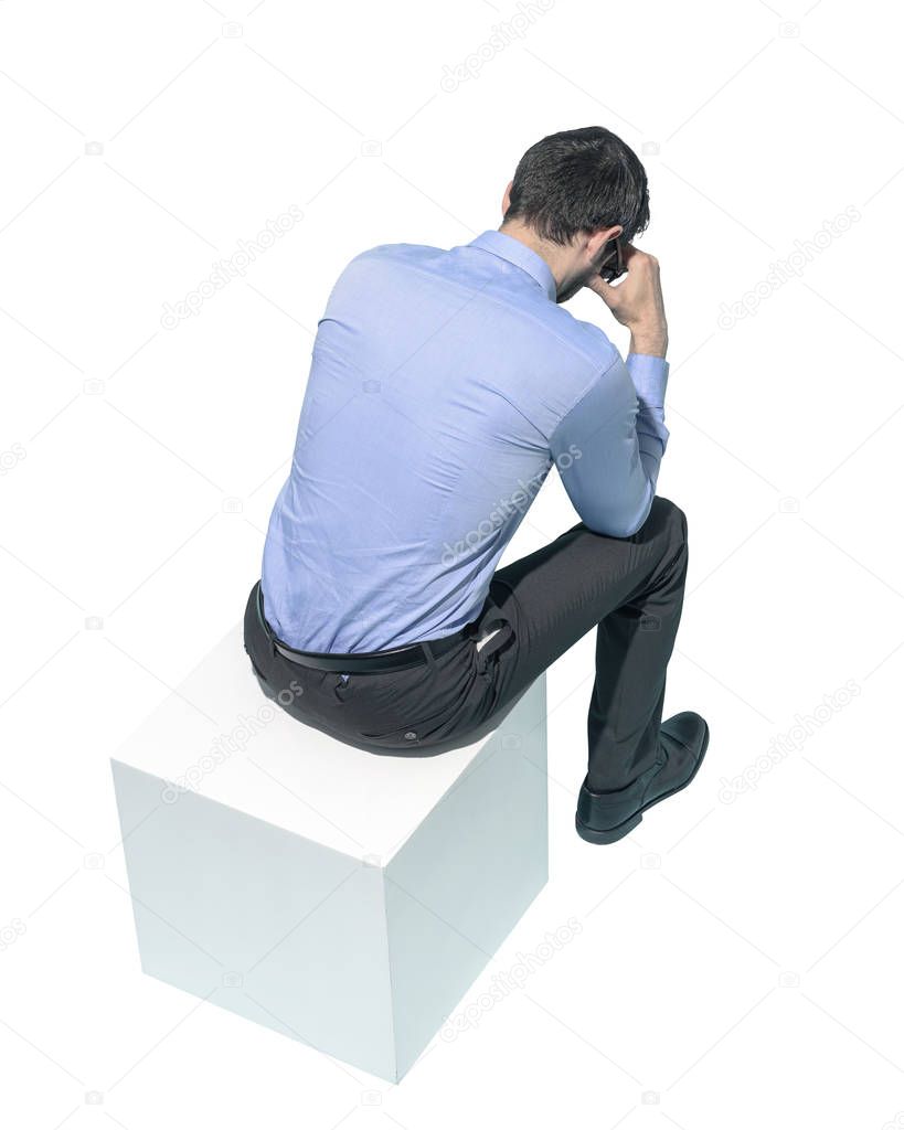Stressed man sitting with head in hands
