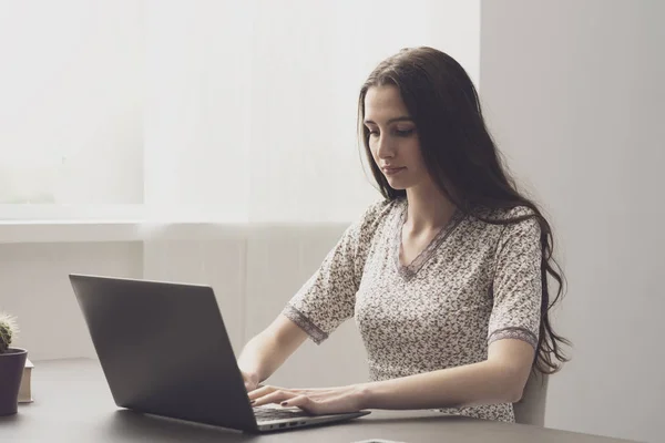 Young woman working with her laptop at home — 스톡 사진