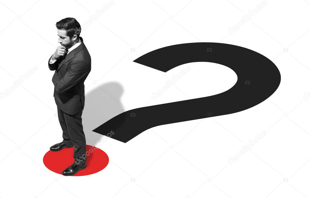 Corporate businessman standing on a question mark