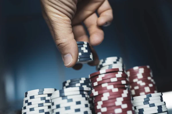 Udany człowiek układania żetonów pokerowych w kasynie — Zdjęcie stockowe