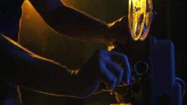 Projektör üzerinde film şeridini ayarlayan operatör