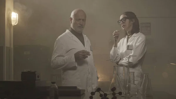 Scientists smoking in a vintage style lab — Stock Photo, Image