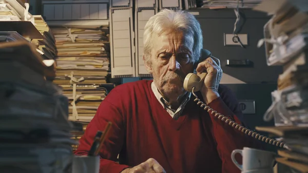 Hombre de negocios respondiendo llamadas telefónicas en la oficina — Foto de Stock