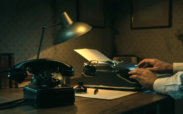 在办公室写字台工作的黑色电影记者 他正在用一台老式打字机打字 — 图库照片