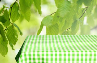 Boş tablo ile renk kareli masa örtüsü ve doğal arka plan bulanık