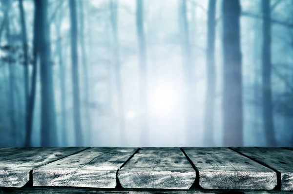 empty wooden table with creepy Halloween background