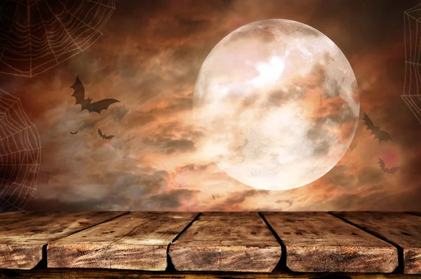 empty wooden table with creepy Halloween background