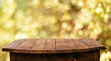 Empty wooden table with blurred natural background clipart