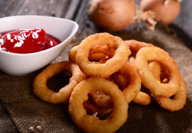 Delicious onion rings snack with sauce clipart