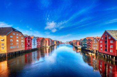Colorful houses over water in Trondheim city - Norway clipart