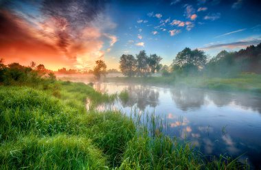 Beautiful summer sunrise over river banks clipart