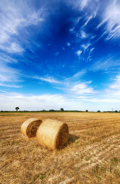 Прекрасный летний пейзаж с тюками сена и облачным небом — стоковое фото