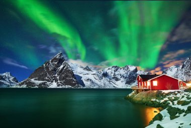 Aurora borealis over winter landscape - lofotens - Norway clipart