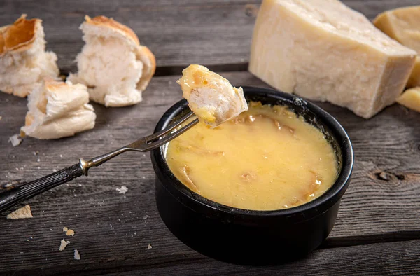 Swiss fondue melted cheese served with bread