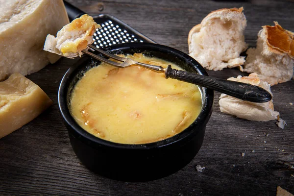 Swiss fondue melted cheese served with bread