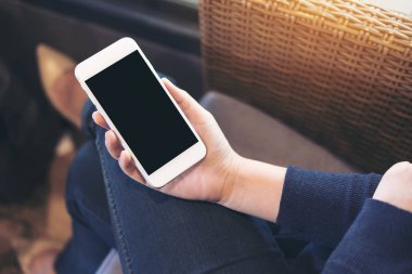 Bir kadın eli boş siyah perde ile beyaz cep telefonu leke tutarak mockup görüntü 