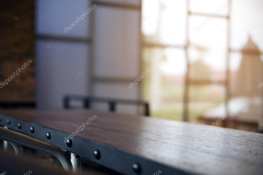 Closeup image of loft style wooden table in cafe with blur bokeh abstract vintage background