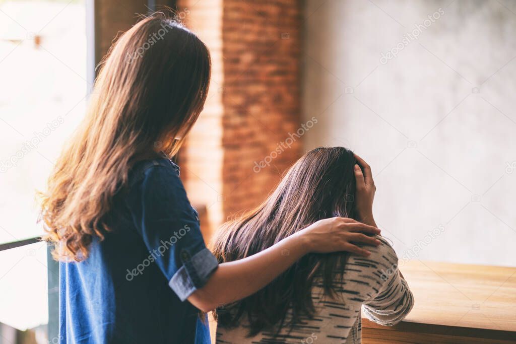 A woman comforting and giving encouragement to her sad friend