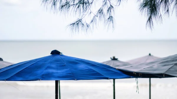 Closeup image of beach umbrellas with sea and sky background