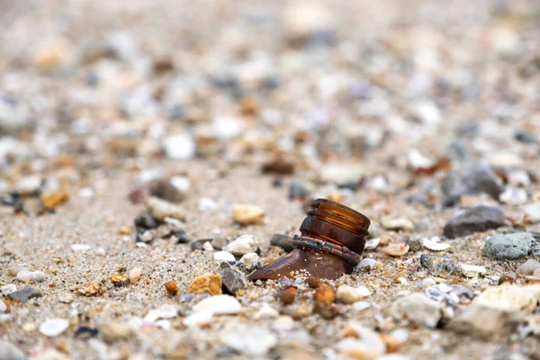 Closeup image of broken bottles on the beach